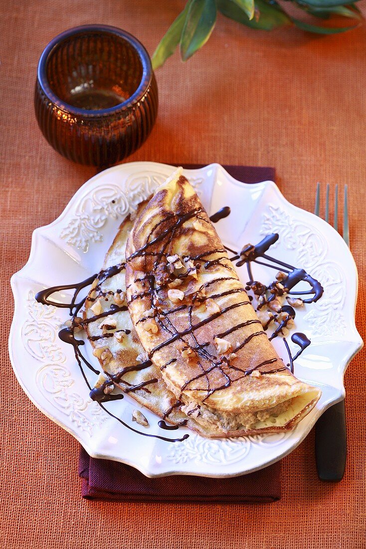 Pancake with nut filling and chocolate sauce