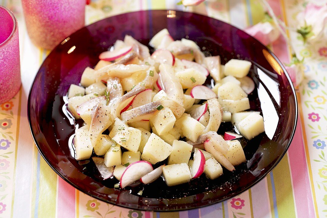 Potato salad with herring and radishes
