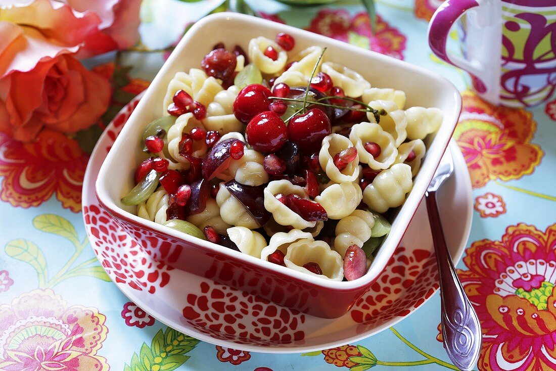 Pasta shells with cherries and pomegranate seeds