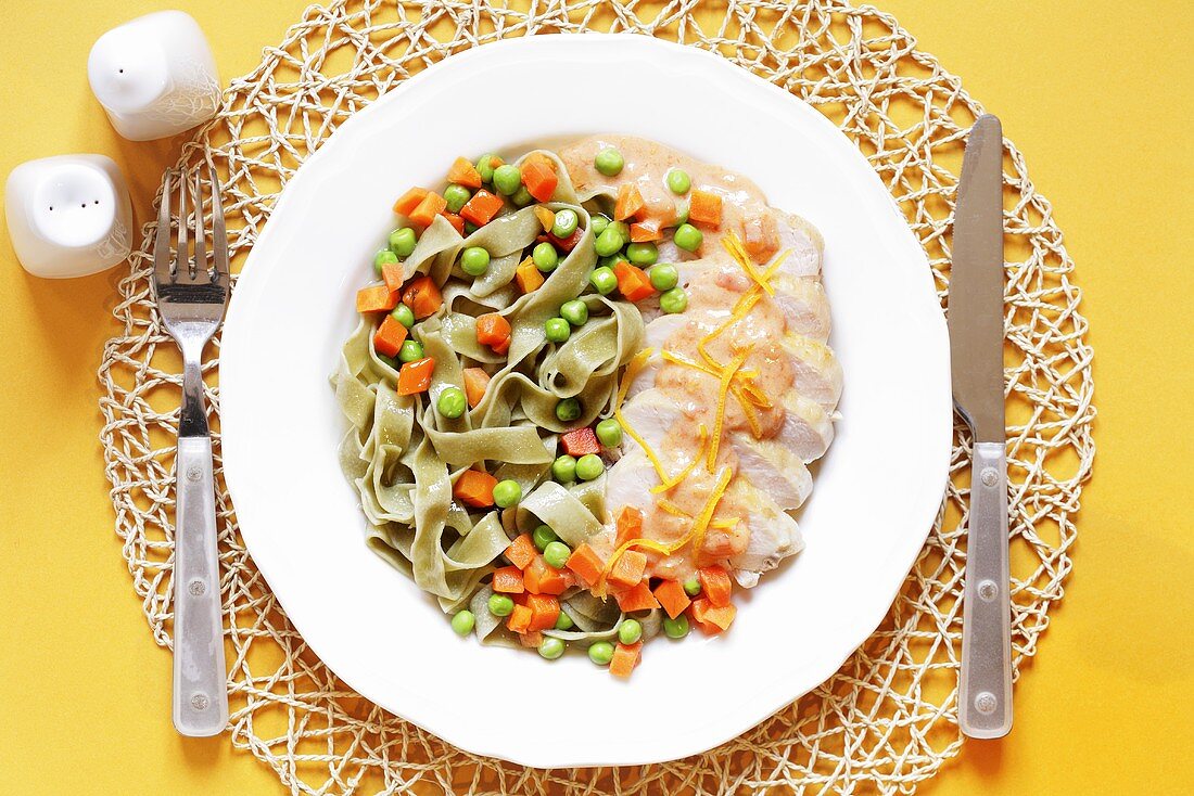 Chicken breast in orange sauce, ribbon pasta and vegetables