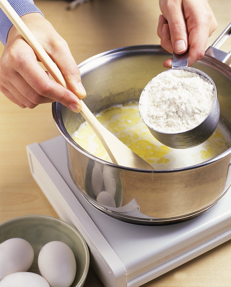 Stirring flour into butter (making choux pastry)