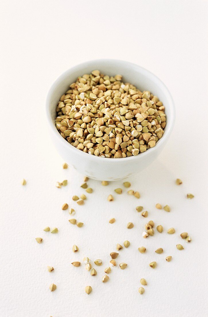 Buckwheat in and in front of a small bowl