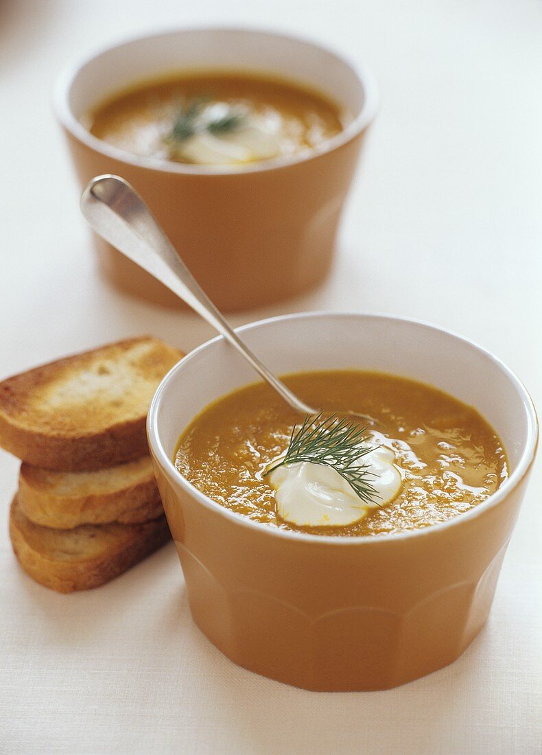 Creamed vegetable soup with a blob of cream and toasted bread