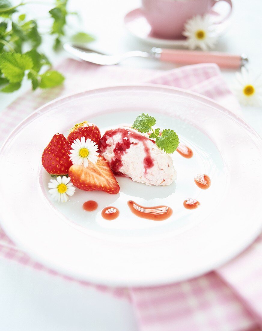 Spoonfuls of strawberry quark with strawberry sauce & flowers