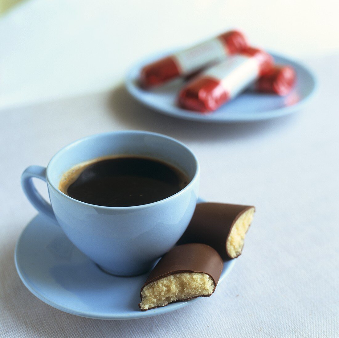 A cup of coffee with marzipan bar