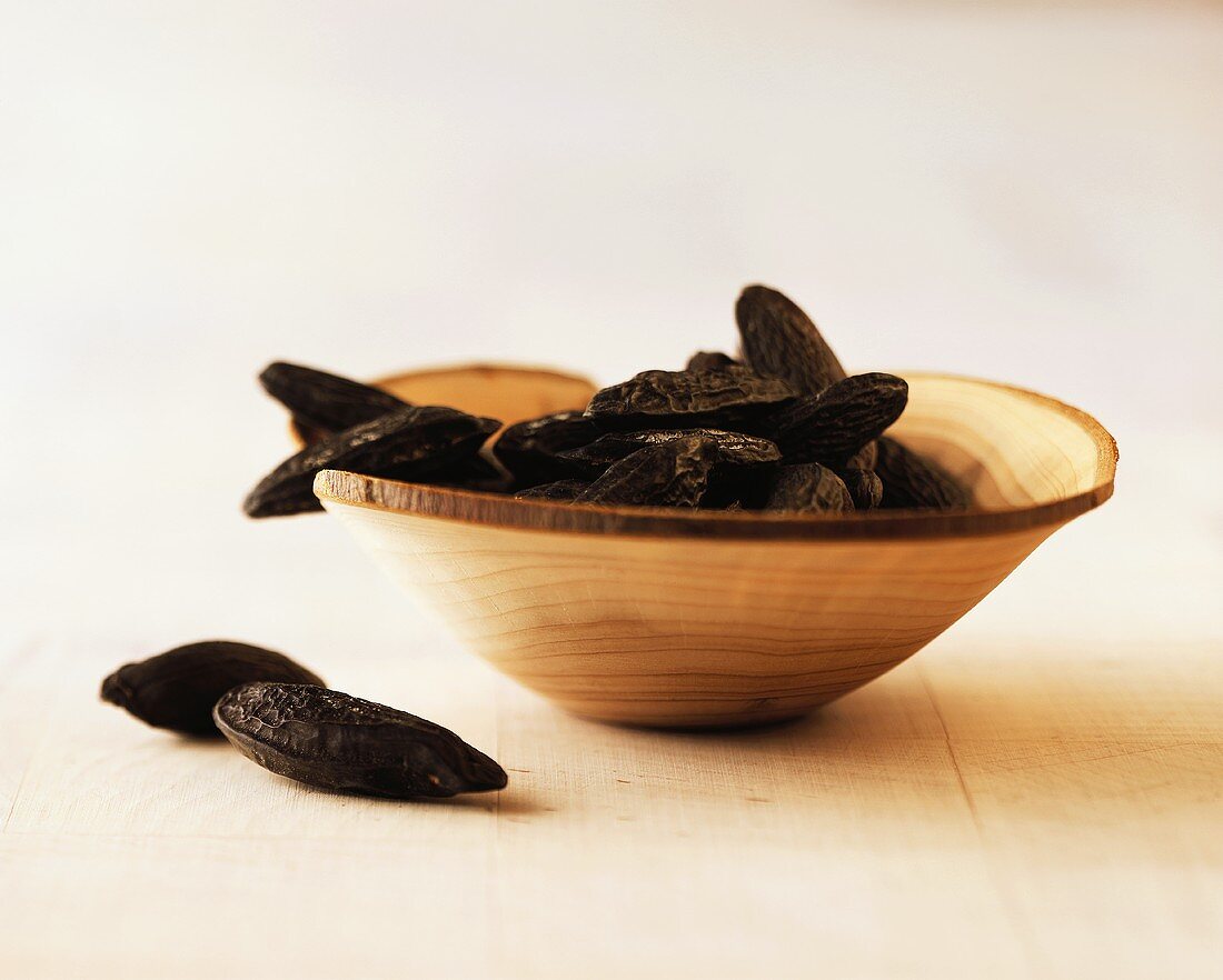 Tonka beans in a wooden bowl (grated for seasoning)