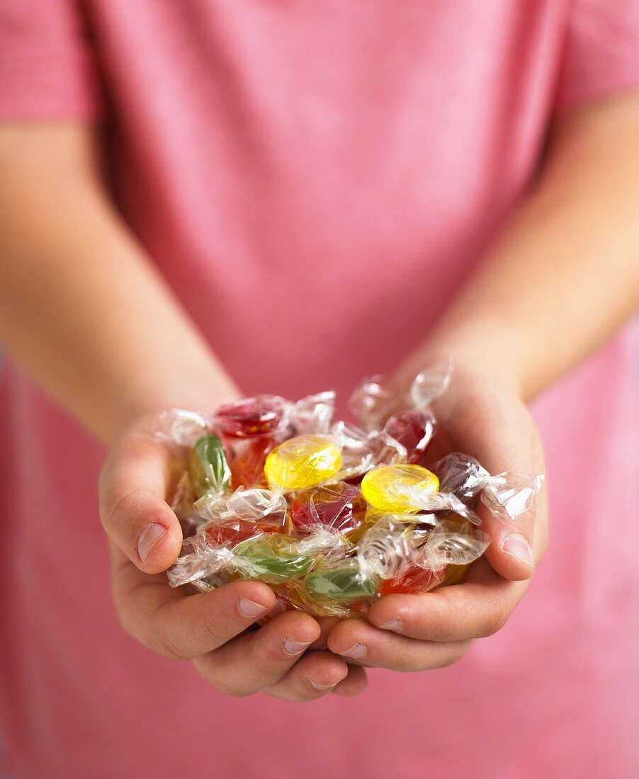 Assorted fruit sweets, in someone's hands