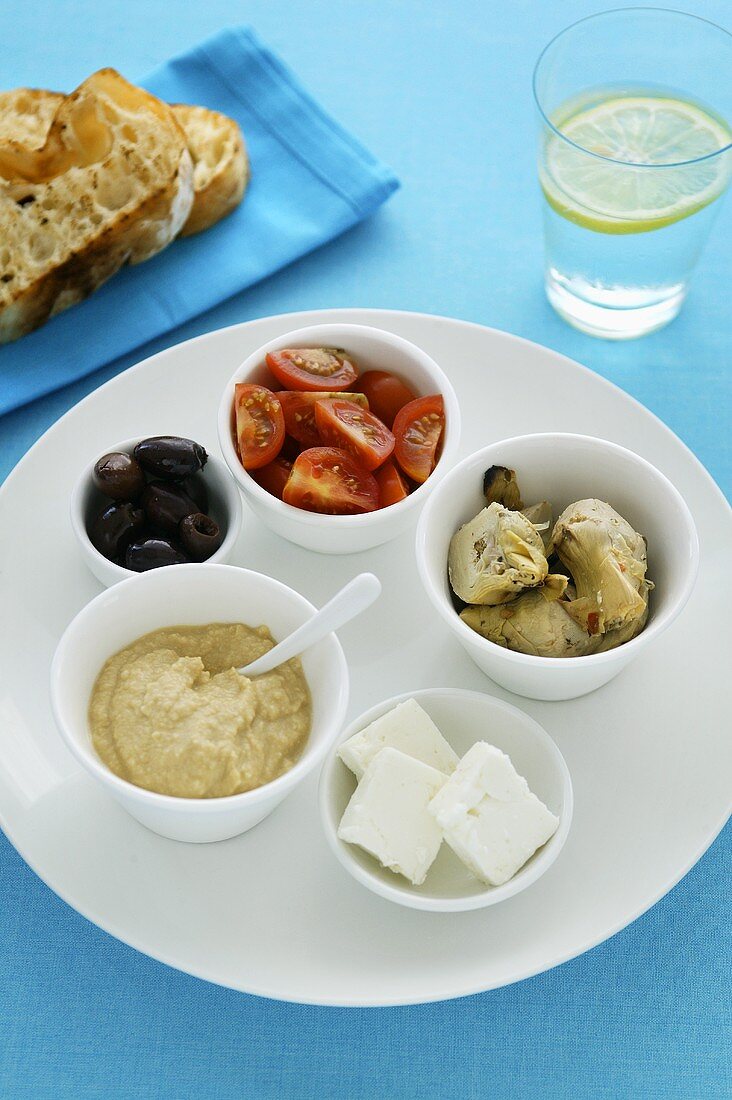 Assorted antipasti in small bowls
