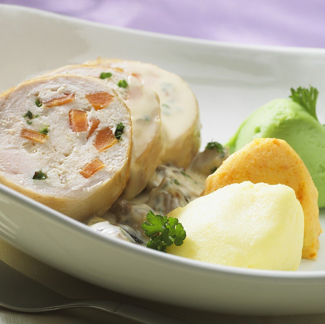 Stuffed chicken roll, sliced, with vegetable puree