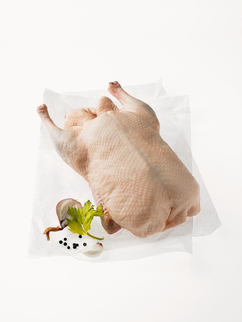 A whole Peking duck on greaseproof paper