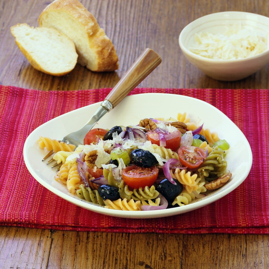 Pasta salad with olives, tomatoes and walnut