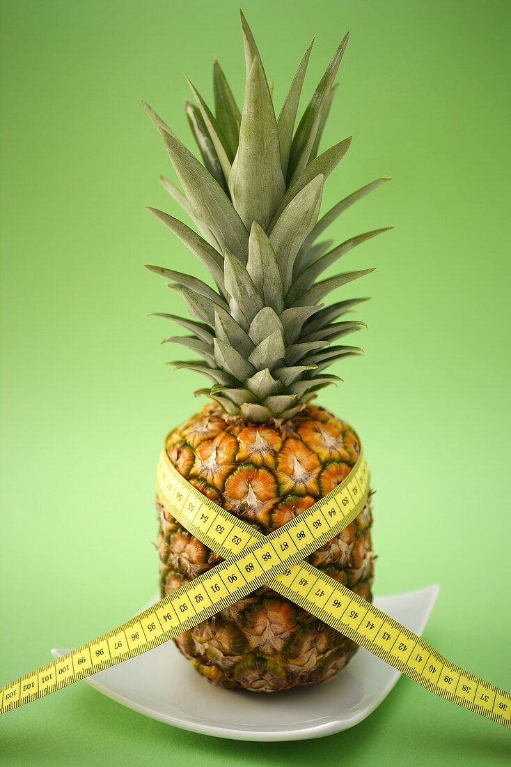 Pineapple with tape measure round it