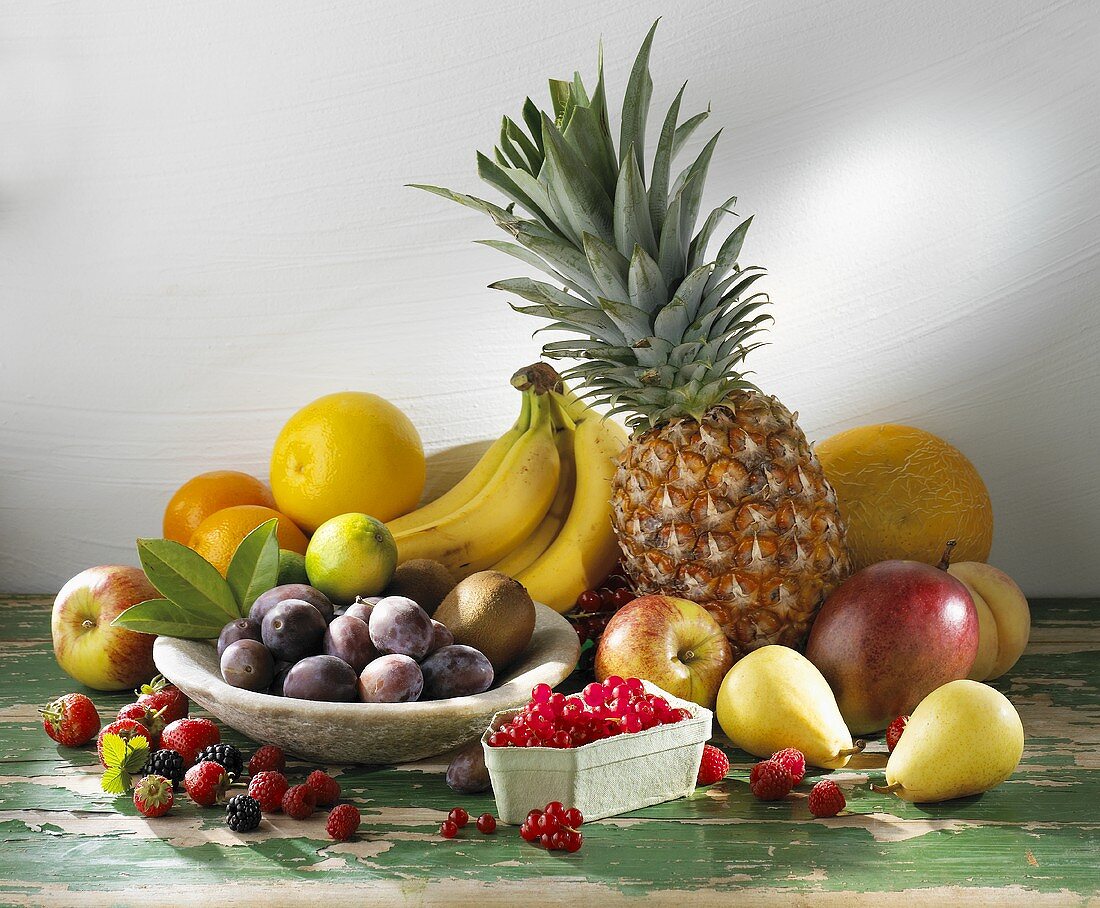 Fruit still life with berries, tropical and European fruit