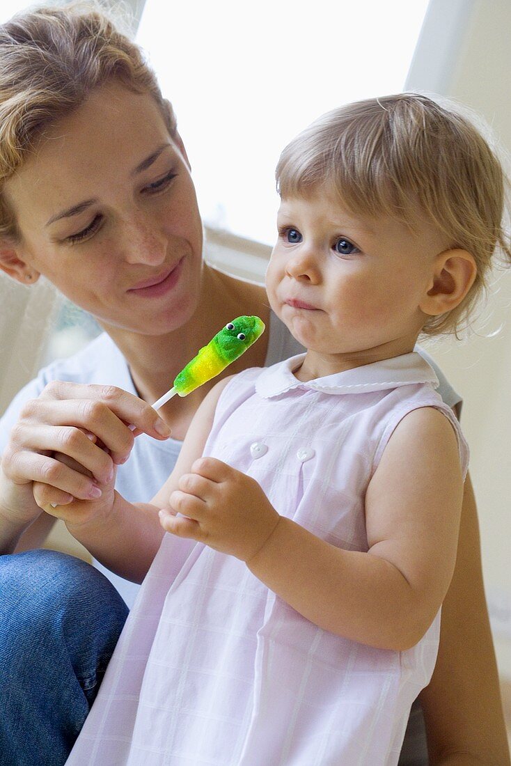 Mutter und kleine Tochter mit einem Lutscher