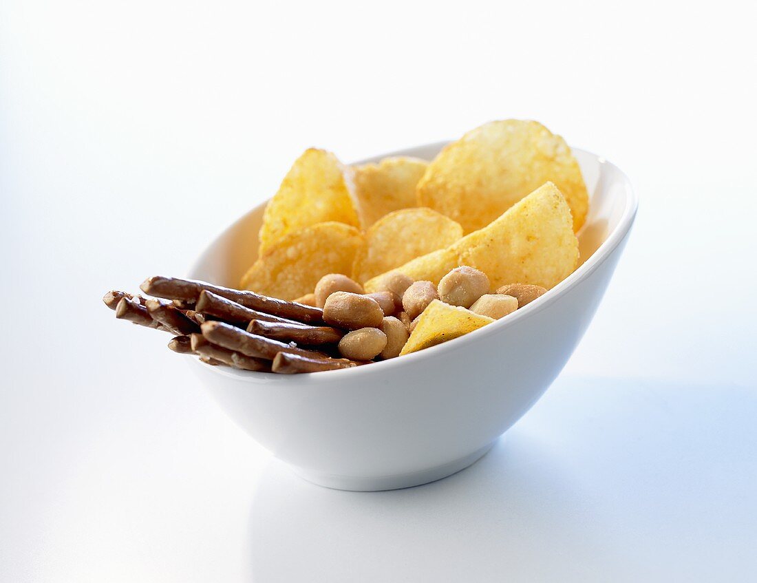 Knabberzeug in einer Schale (Salzstangen, Erdnüsse, Chips)