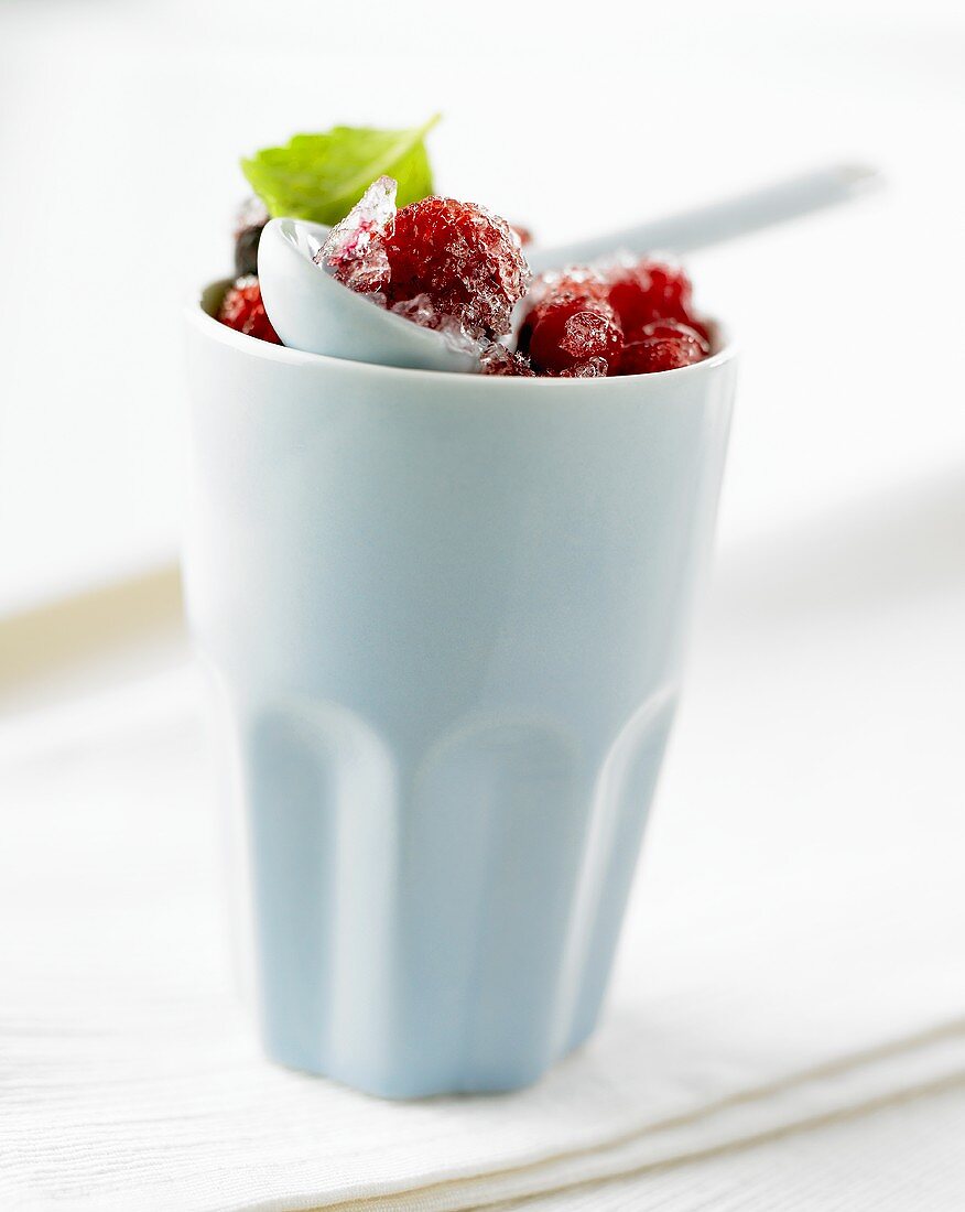 Beaker of frozen raspberries