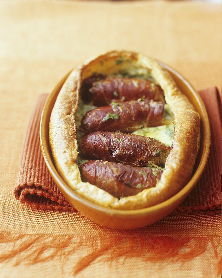 Toad in the hole (sausages baked in batter; England)