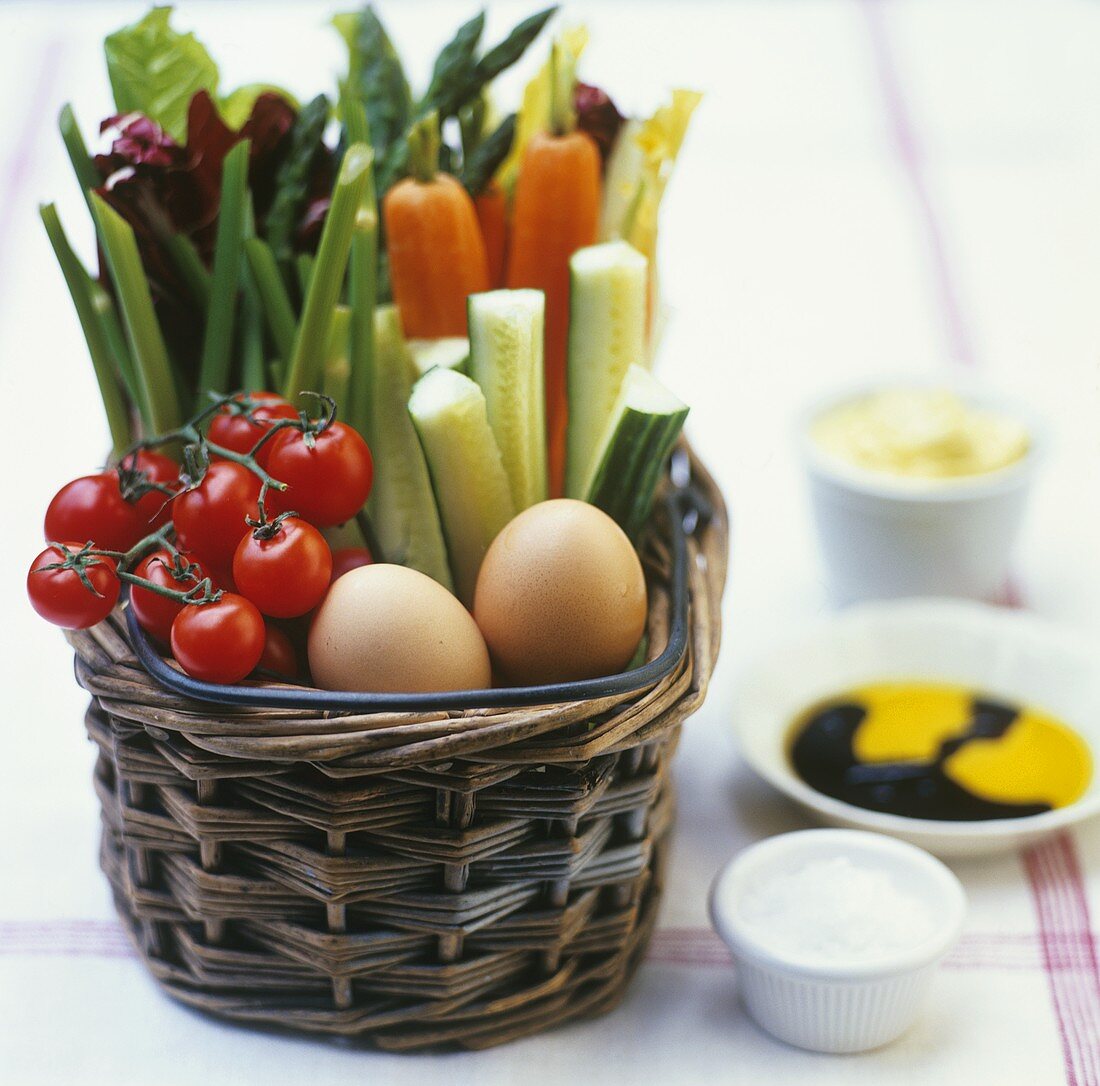 Fresh vegetables and eggs in basket, dips