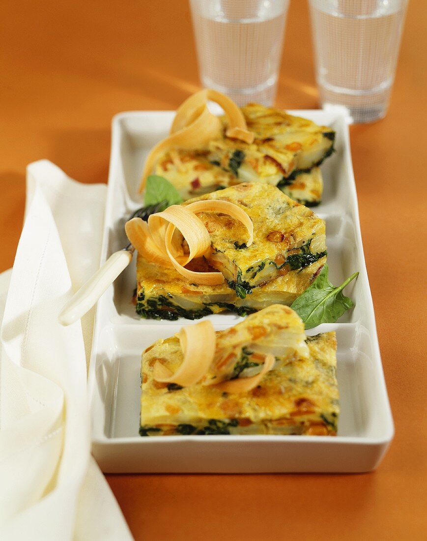 Three pieces of spinach and potato tortilla