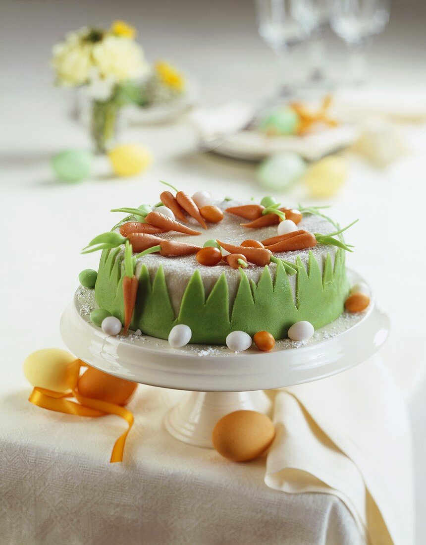 A carrot cake on a table laid for Easter