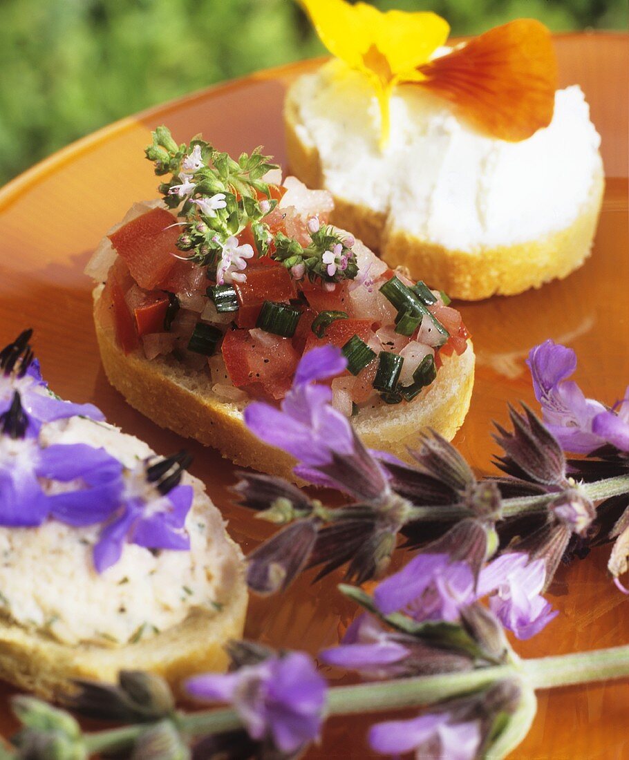 Three canapés with edible flowers