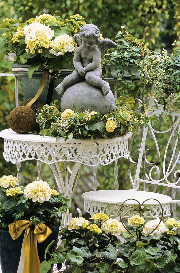 White hydrangeas and a cherub on a terrace