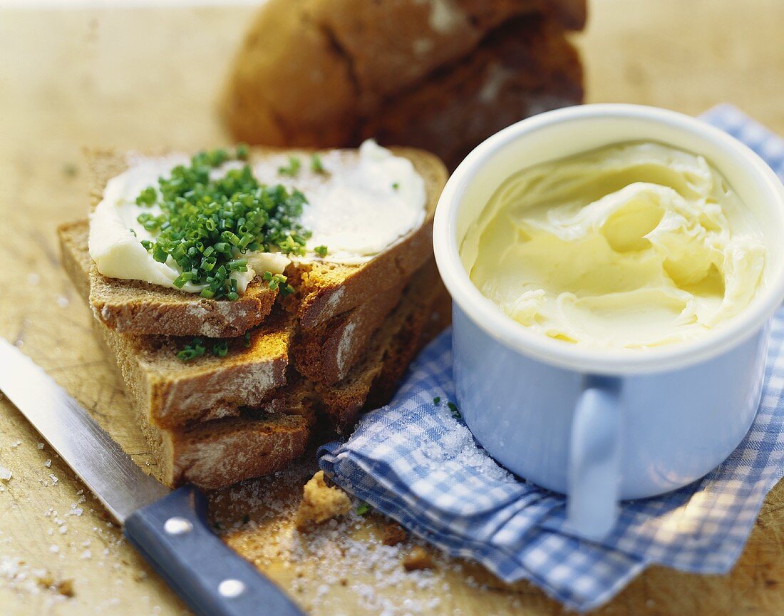 Bread and butter with chives, fresh butter beside it