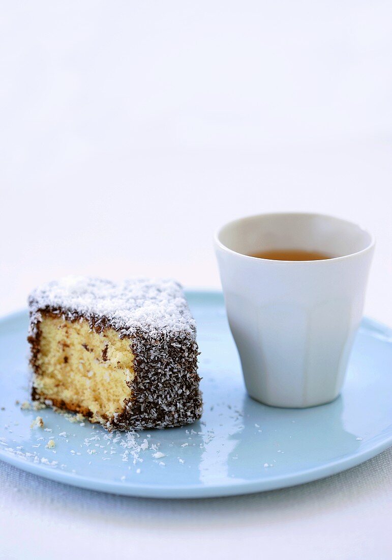 Lamington (Australian sponge cake) with teacup