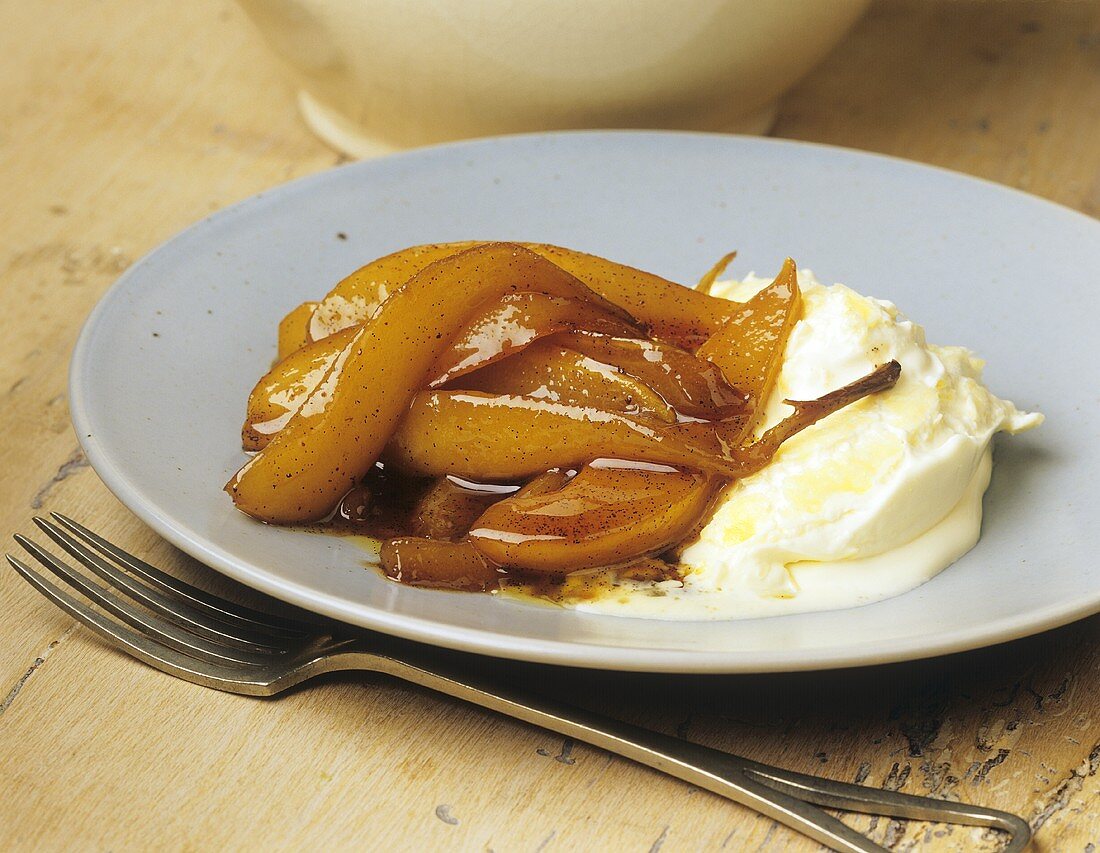 Tipsy pear wedges with vanilla syrup and clotted cream