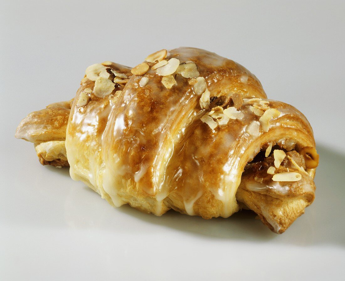 Nut croissants with icing and flaked almonds
