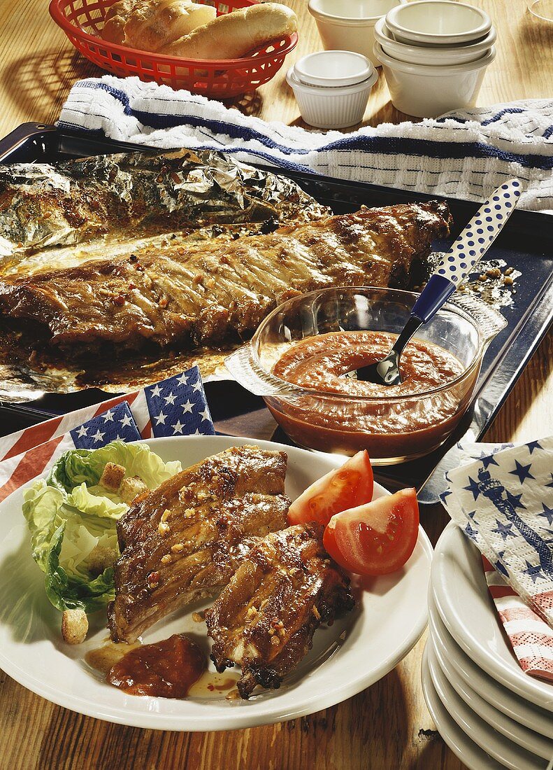 Pork ribs on a plate and a baking tray