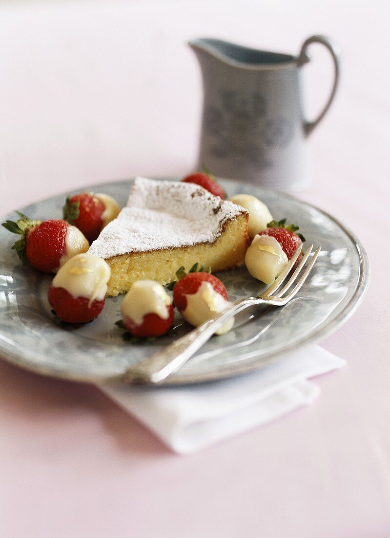 White chocolate cake with chocolate-dipped strawberries