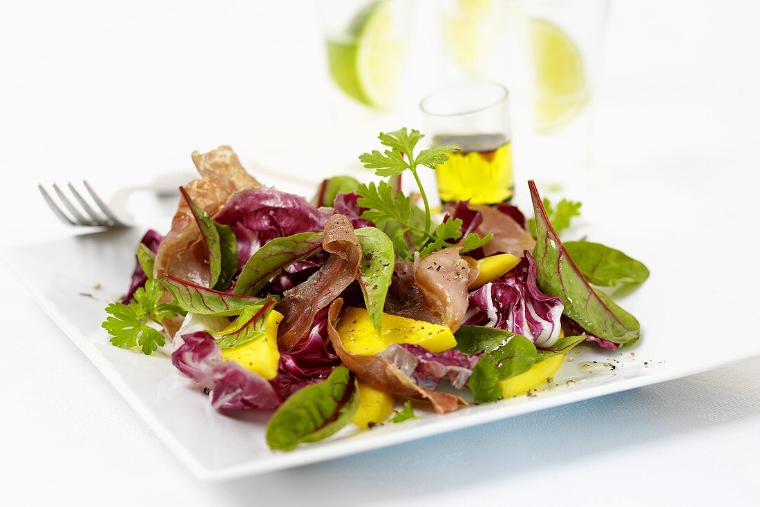 Mixed salad leaves with mango wedges