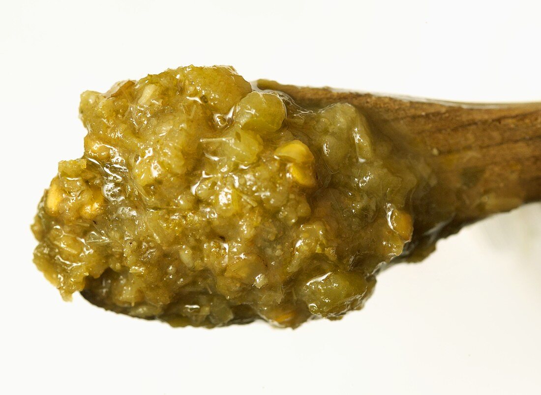 Green curry paste on a spoon