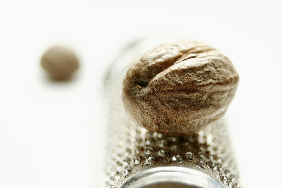 Nutmeg lying on a nutmeg grater