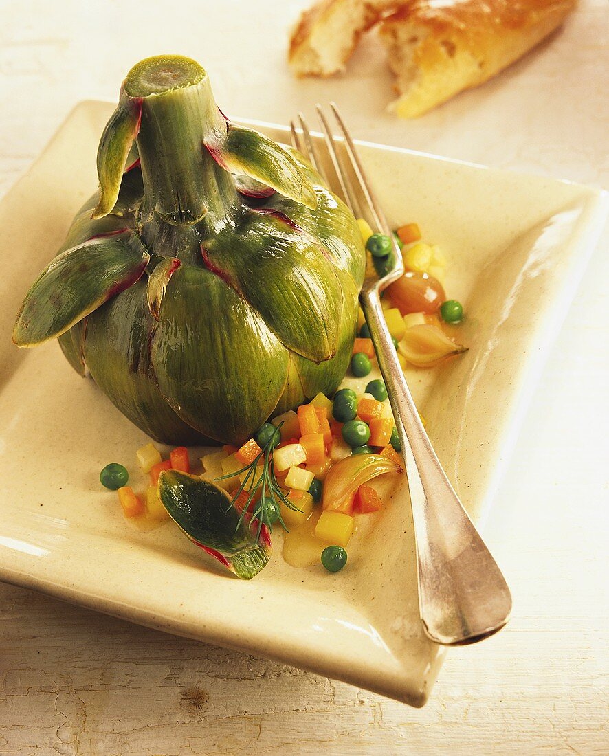 Cooked artichoke with vegetable accompaniments