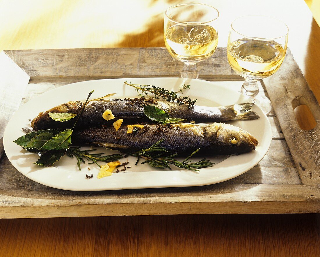 Two whole fish prepared with herbs and spices