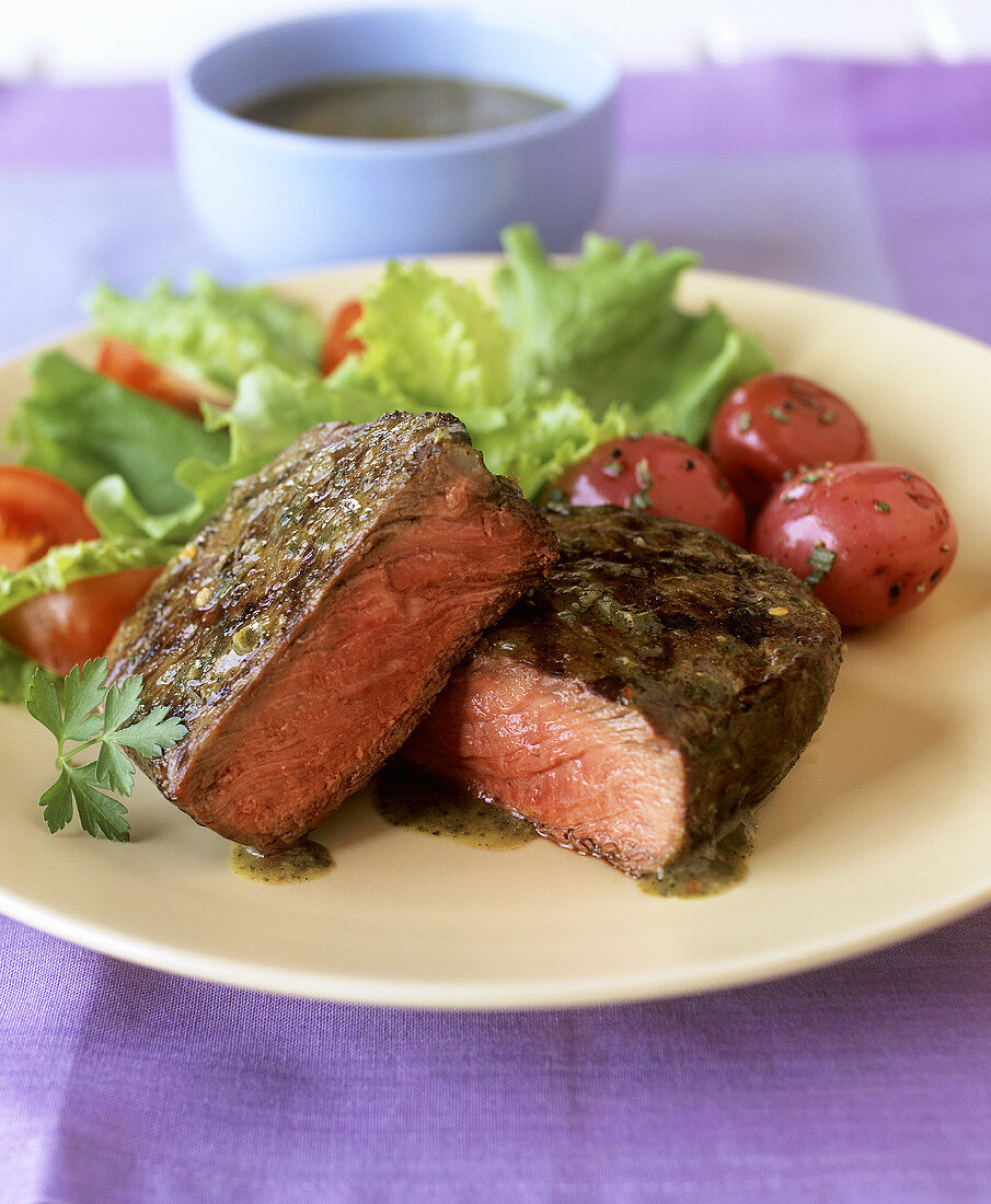 Beef fillet steak with herb sauce and salad