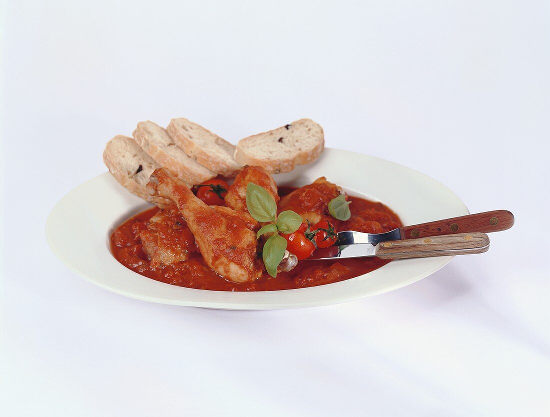 Pollo al pomodoro (chicken stew with olive bread, Italy)