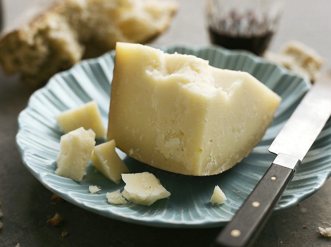 Manchego on a plate with knife and wine glass