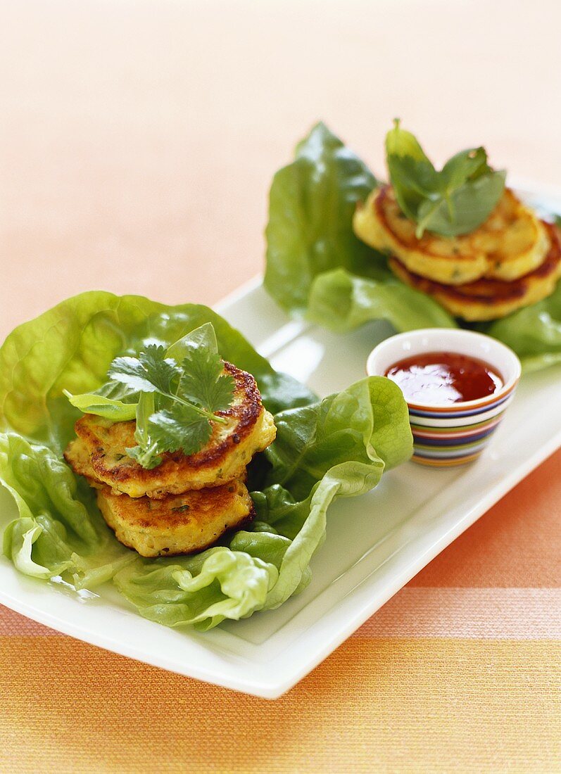 Corn cakes on lettuce with dip