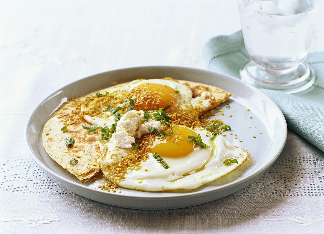 Fried eggs with duka, mint and sheep’s cheese