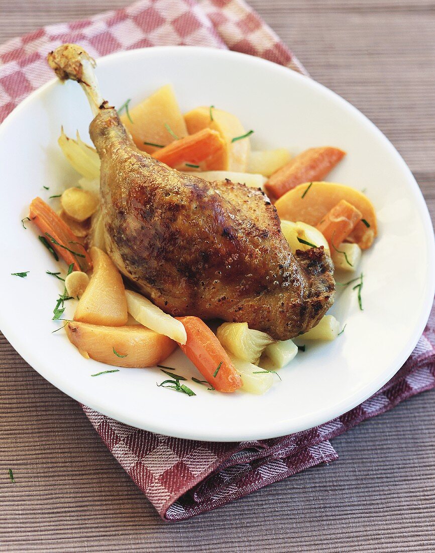 Duck leg on two different root vegetables