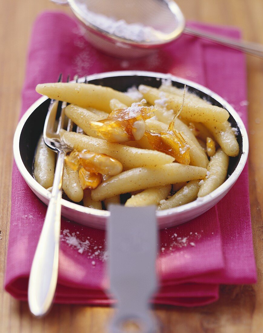 Sweet potato noodles with almond praline & icing sugar