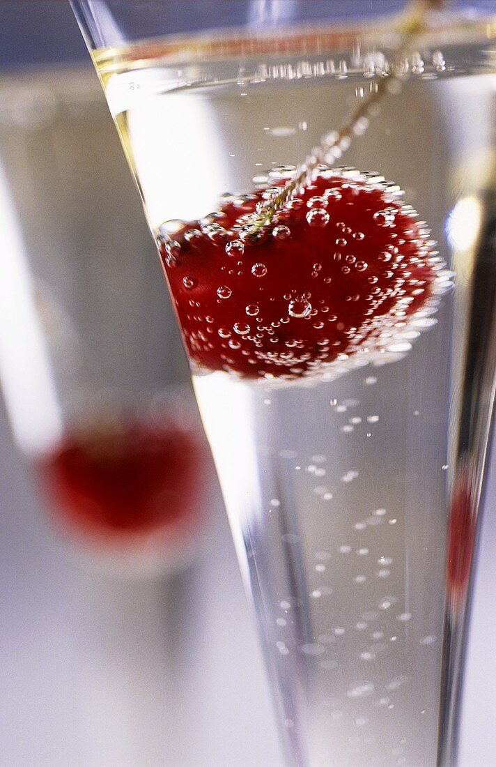 Champagne in glass with cherry