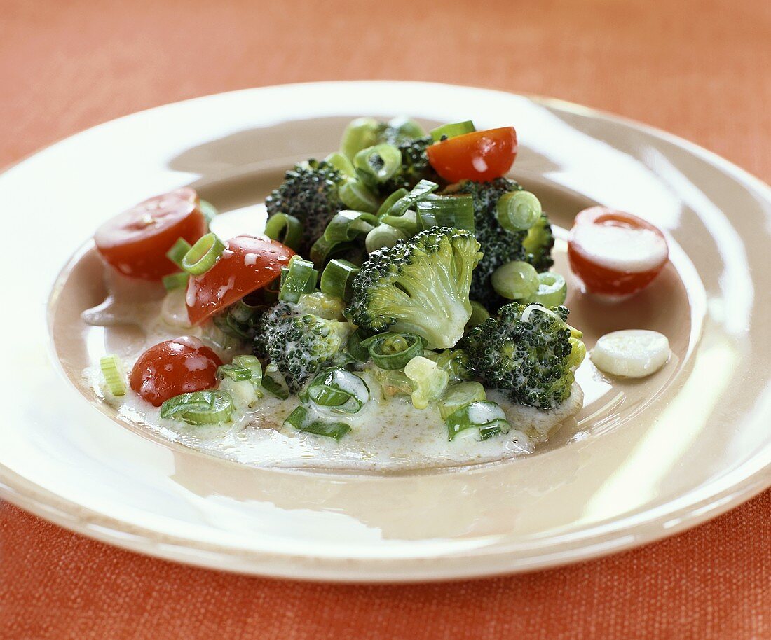 Broccoli salad with cherry tomatoes and spring onions