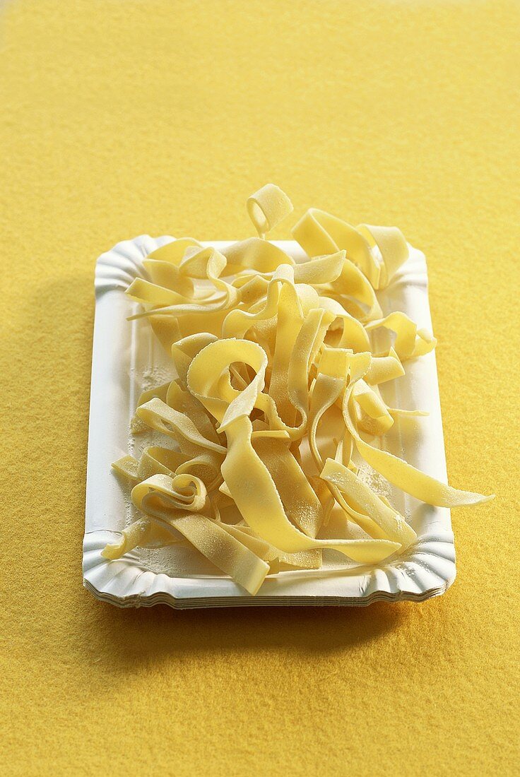 Ribbon pasta on a paper plate