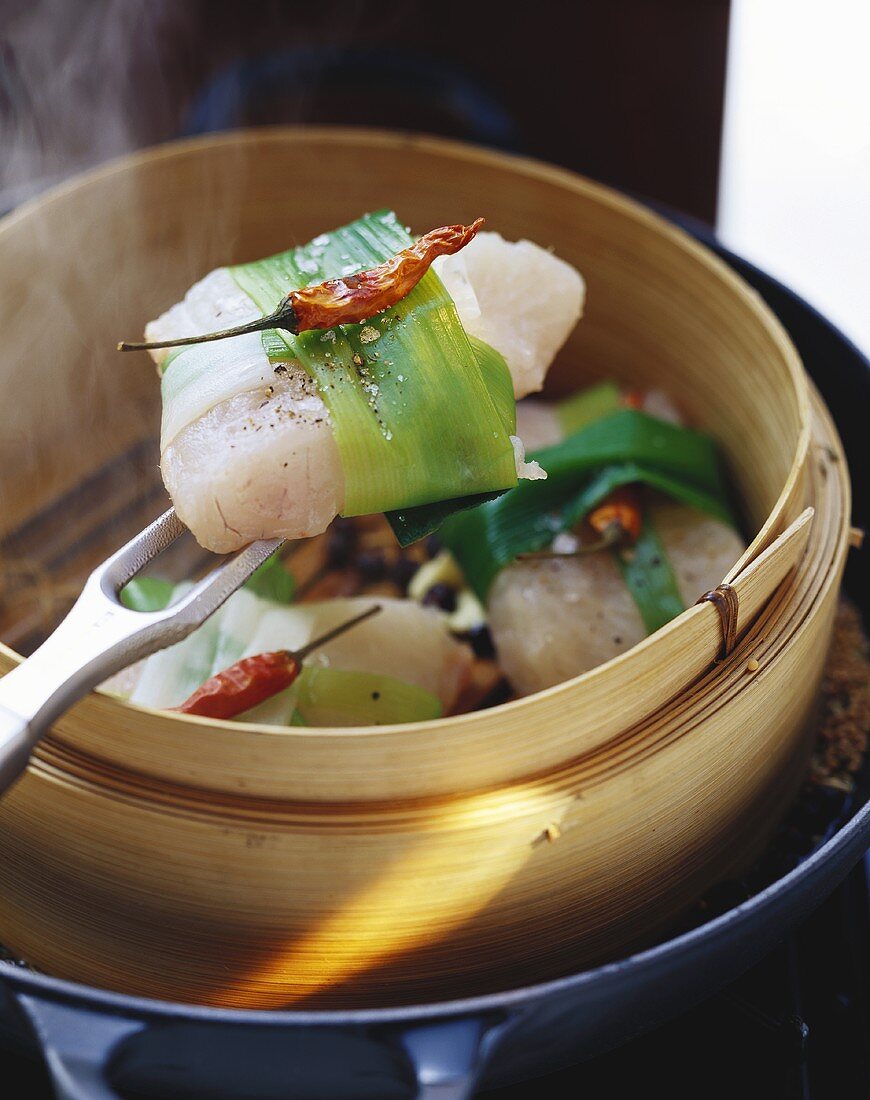 Catfish fillets steamed over spiced stock