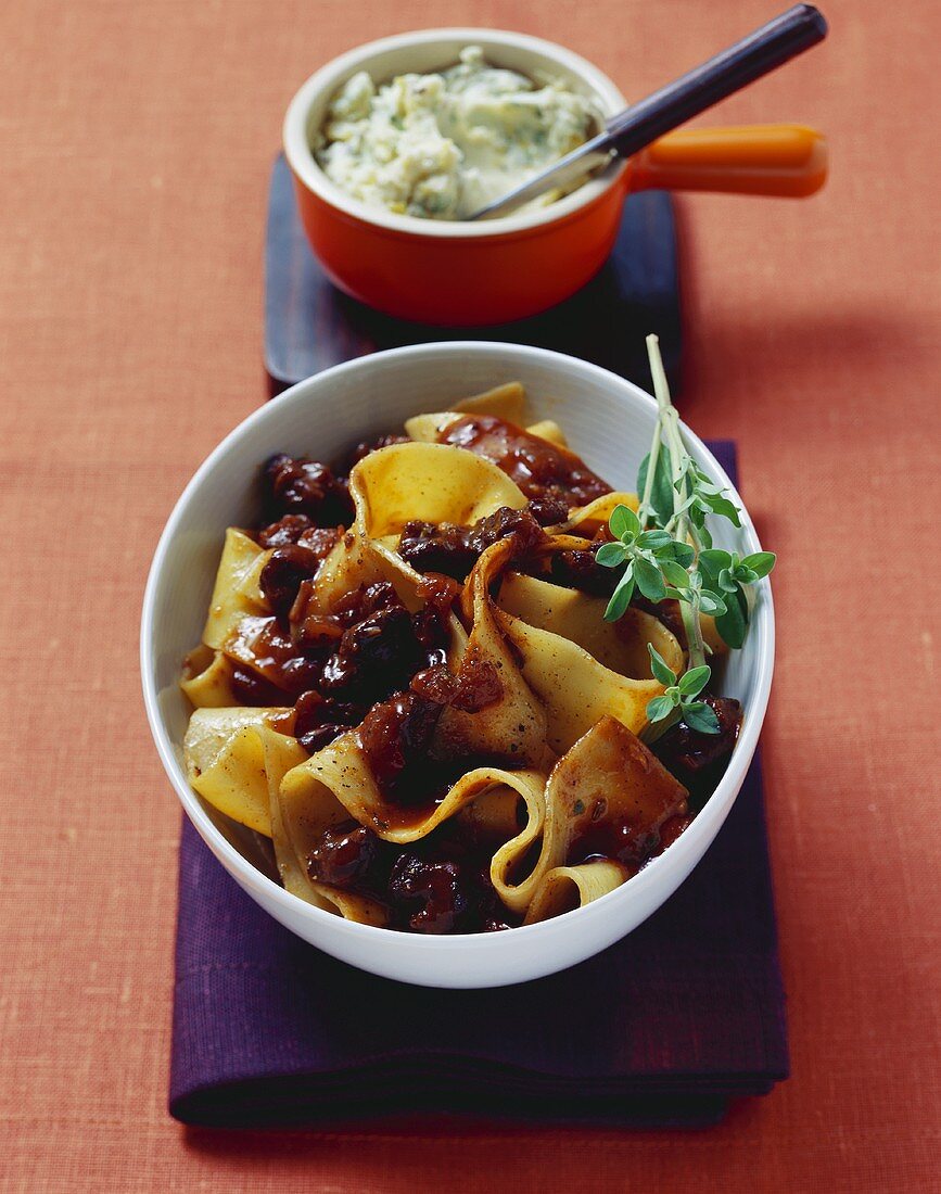 Broad pasta with beef sauce, marjoram and lemon