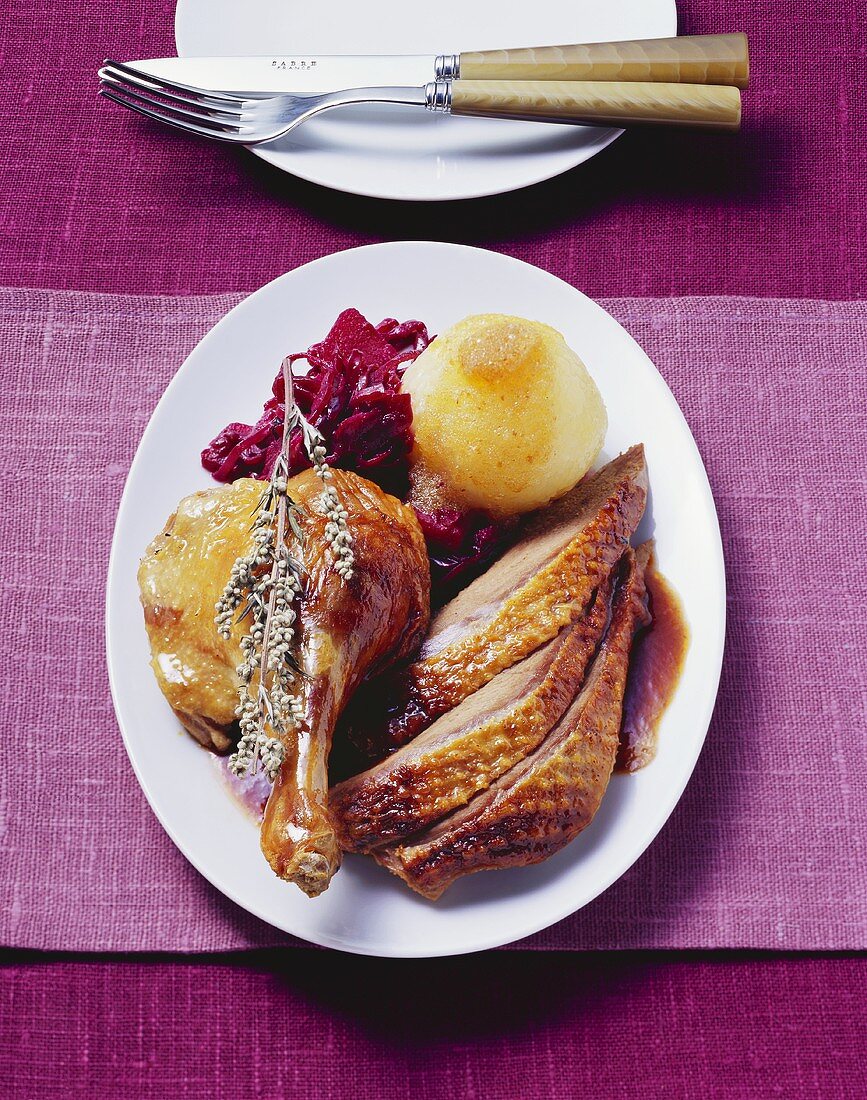 Roast Barbary duck with marzipan apple, red cabbage & dumpling